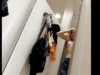 Girl with nice tits in fitting room being spied.